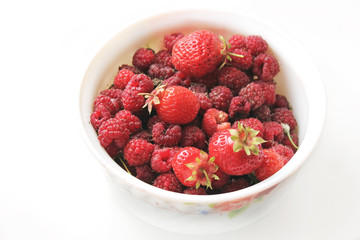 Raspberries in a plate on a white background