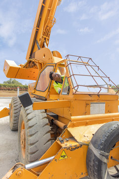 Construction worker operating crane