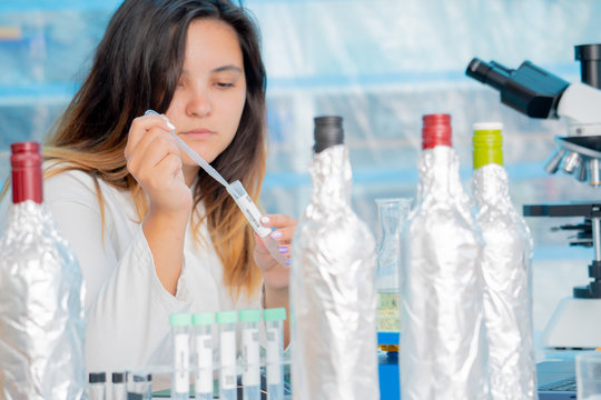 Young female technician in the quality control laboratory use Refractometer