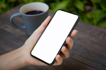 female hands holding phone with isolated screen over the table