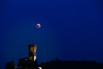 red moon eclipse on clock tower