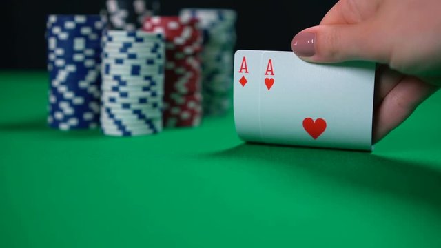 Poker player checking hand, double aces, lucky cards, successful game, winner. High chances of winning, strong strategy