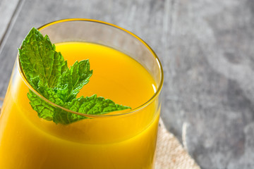 Mango Lassi dessert. Traditional Indian drink on wooden table. Copyspace