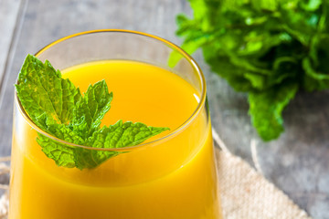 Mango Lassi dessert. Traditional Indian drink on wooden table. Copyspace