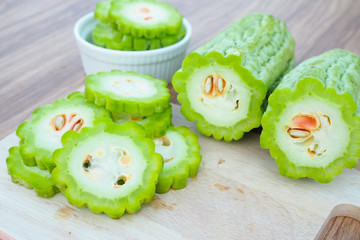 Fresh bitter gourd on wooden table