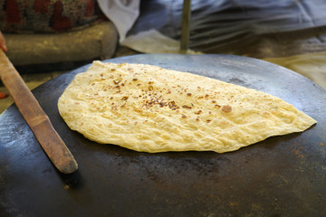 Turkish Gozleme.  Gozleme is a traditional Turkish dish featuring flat bread stuffed with a range of delicious fillings (cheese, patato, spinach, mince etc.) . Baked on sheet iron.