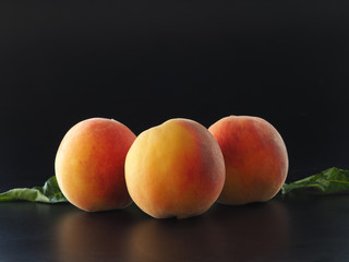 Fototapeta na wymiar Peaches on a black background