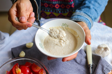 Raw vegan mayonnaise made of blended cashew, sesame seeds, sunflower seeds, mustard powder,...