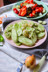 Green fresh cucumber salad with onion rings spices, herbs, garlic and unrefined oil. Raw vegan lunch, vegetarian healthy dinner