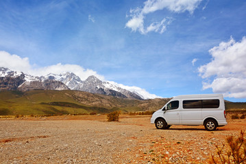 Plakat natural mountain landscape with a van and car with blue sky background