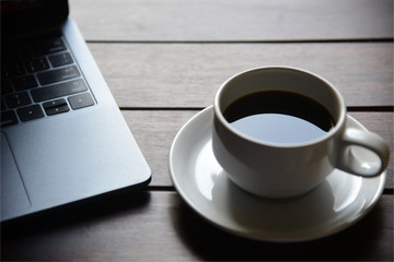coffee cup with Laptop at home office.