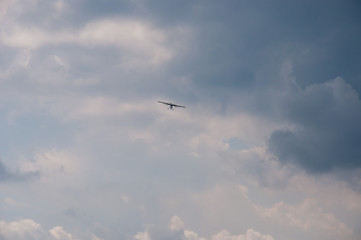 Fototapeta premium White plane in the blue sky. The concept of travel, recreation and technology. The aircraft is landing