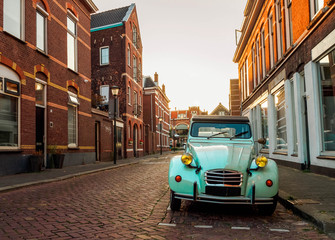 Fototapeta na wymiar A stylish retro car in blue on the street in the Dutch city of Vlaardingen (Rotterdam, Holland, the Netherlands)