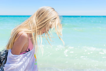 Naklejka premium Girl teenager in profile with disheveled hair on the sea.