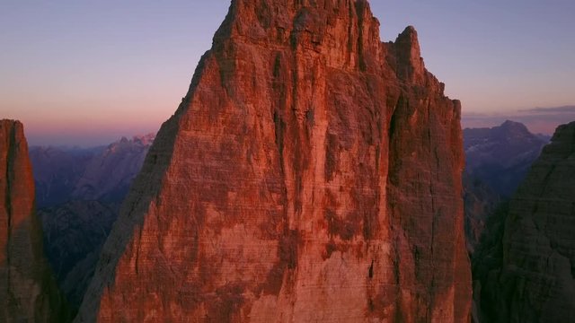 tre cime di lavaredo drone aerial view at sunset flying close to the top