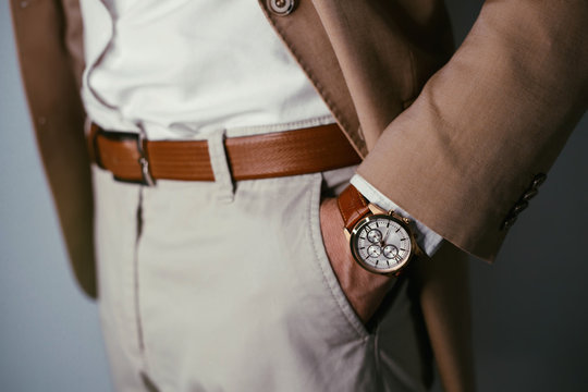 Vintage smart casual outfit outdoor.Fashion model man posing in office.Suited man posing.closeup fashion image of luxury watch on wrist of man.body detail of a business man.Not isolated.