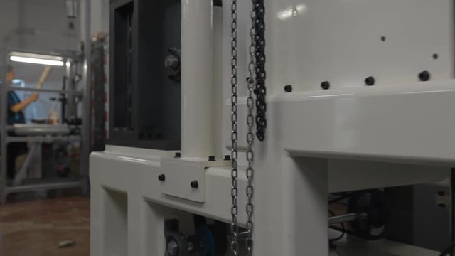 Machinery shop. Punching machine. Die cutting of paper or carton templates for disposable dishes production. Manufacturing from environmentally friendly recyclable materials. Moving parts of mechanism