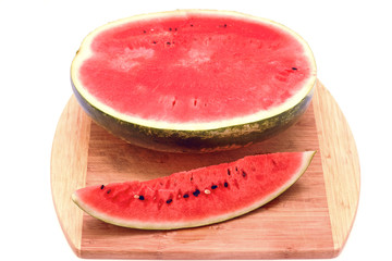 Watermelon cut in half on a wooden board. A piece of watermelon. Isolated object on white background.