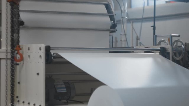 Machinery shop. Punching machine. Die cutting of paper or carton templates for disposable dishes production. Manufacturing from environmentally friendly recyclable materials. Moving parts of mechanism