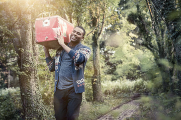 Young man carrying cooler