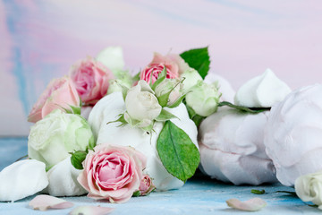 Flower arrangement with summer roses on a pink background