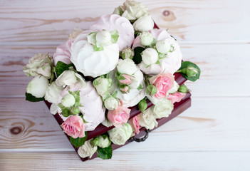 Flower arrangement with summer roses on a pink background