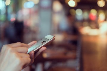 Woman using smartphone on cafe, During leisure time. The concept of using the phone is essential in everyday life.