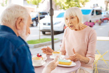 Share love. Nice senior couple communicating and visiting cafe