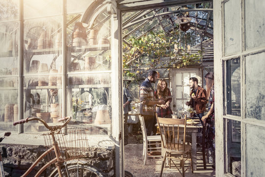 Young people having party in greenhouse