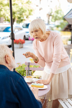 Hot dispute. Disappointed senior couple fighting and senior woman gesturing