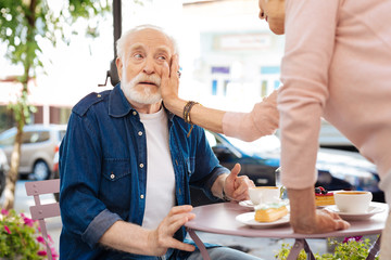 Love through years. Attractive senior couple flirting and having lunch