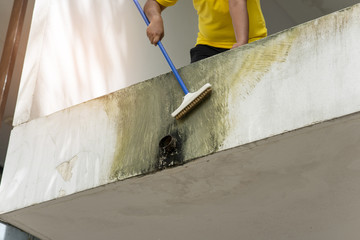 Worker is clean the wall.