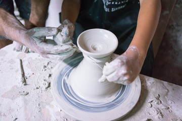 Ceramic dishes in working process. Creating ceramic pieces. Tradicional ceramic factory in spain. Father teaching the art of ceramic making.