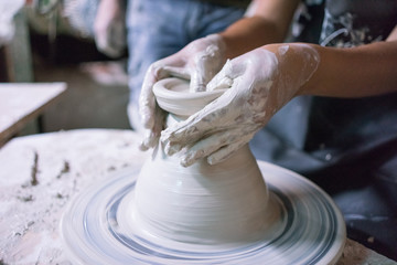 Ceramic dishes in working process. Creating ceramic pieces. Tradicional ceramic factory in spain. Father teaching the art of ceramic making.