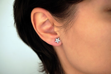 Woman wearing amazing earrings with diamonds