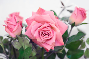 Artificial pink roses. Imitation of flowers decorative.