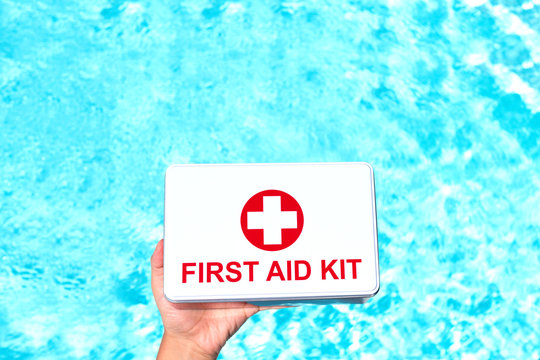 First aid kit in the female hands. Concept