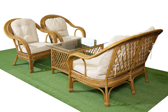 Set of rattan furniture on artificial grass isolated on white background