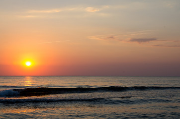 Obraz premium Sunset sky background. Natural Sunset Sunrise Over Ocean. Bright Dramatic Sky And Blue Water. Colorful Nature Landscape