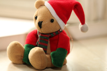 A christmas doll sitting on the window sill