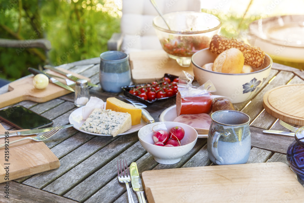 Wall mural rustic garden table prepared for an outside meal with the family on a sunny day