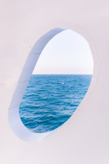 Obraz na płótnie Canvas White Boat Crackled Window on Blue Sea and Sky