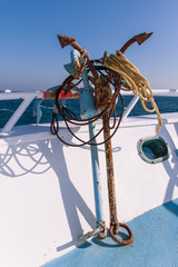 Rusty Anchors on Dive Boat Deck in the Sun with Sea in the Background.