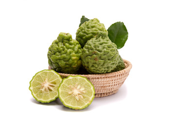 The kaffir lime leaves in the basket on a white background.