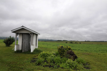 Fototapeta premium Wooden Hut In Green Pasture