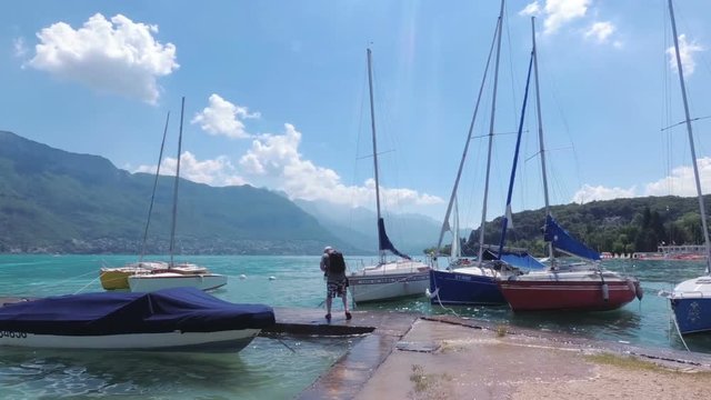 Waves on the lake in the resort town of Annecy. The photographer takes pictures of beautiful views of the mountains and the lake. France.