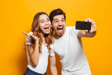 Happy young couple taking selfie with mobile phone - Powered by Adobe