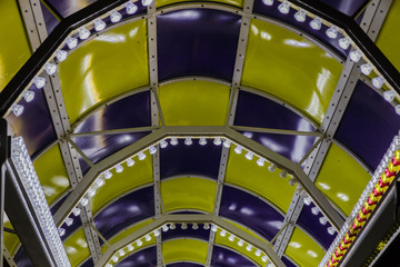 Bright colored lamps on carousels at night.