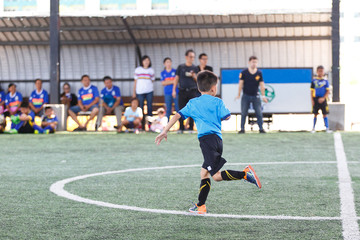 Young Asian football player in blue jersey between competition.