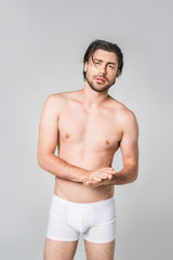 Fototapeta premium portrait of thoughtful man in white underwear isolated on grey